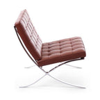 Barcelona Chair - scissoring chrome frame supporting the tufted seat and back