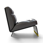 A modern lounge chair with dark gray leather upholstery and a sculptural black metal frame, featuring a yellow accent on the lower leg, shown against a plain white background.