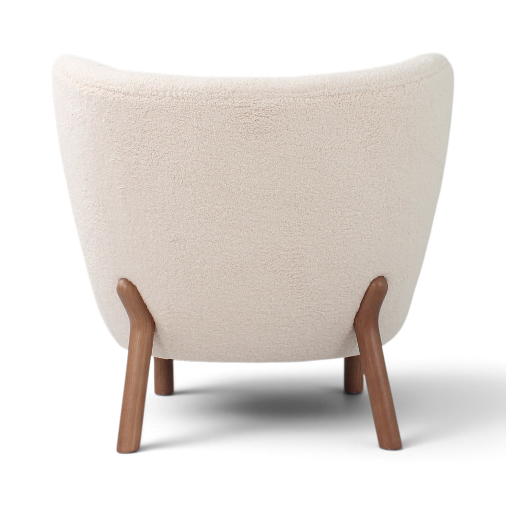 Little Petra Lounge Chair - back view in cream bouclé with wooden legs