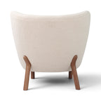 Little Petra Lounge Chair - back view in cream bouclé with wooden legs