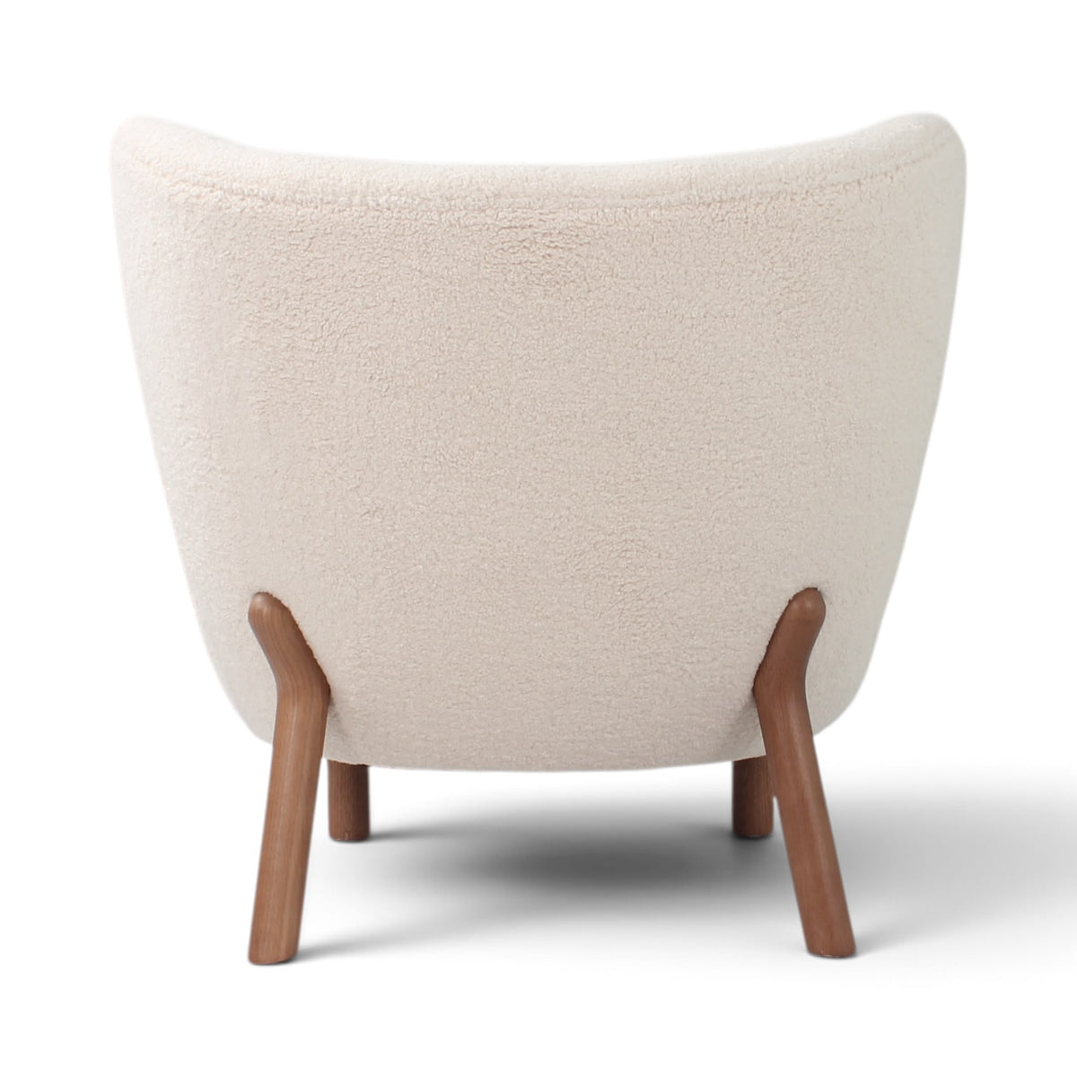 Little Petra Lounge Chair - back view in cream bouclé with wooden legs