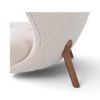 Little Petra Lounge Chair - close-up of cream bouclé and curved wooden leg