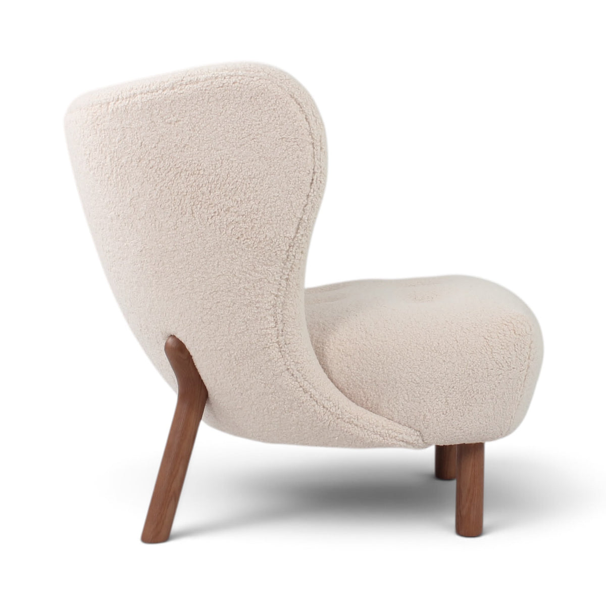 Little Petra Lounge chair with a textured cream upholstered shell and tapered walnut wooden legs | Nue Modern