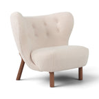 Little Petra chair upholstered in cream sherpa fabric with a tufted backrest and tapered wooden legs | Nue Modern