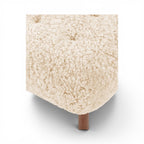 Close-up of the sherpa little Petra Ottoman with walnut legs | Nue Modern