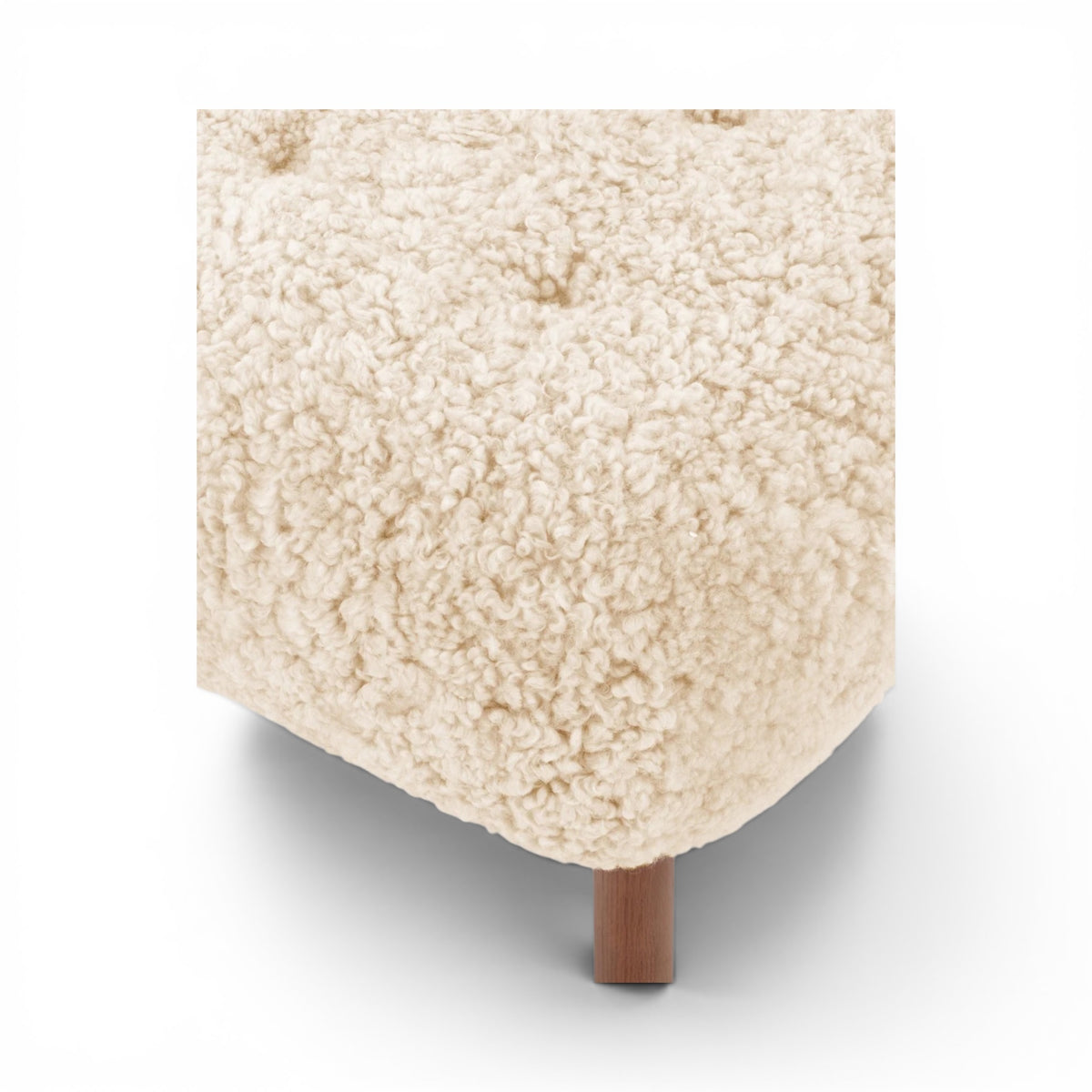 Close-up of the sherpa little Petra Ottoman with walnut legs | Nue Modern