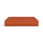 Mah Jong orange rectangular cushion with a fine vertical striped texture, shown against a plain white background.