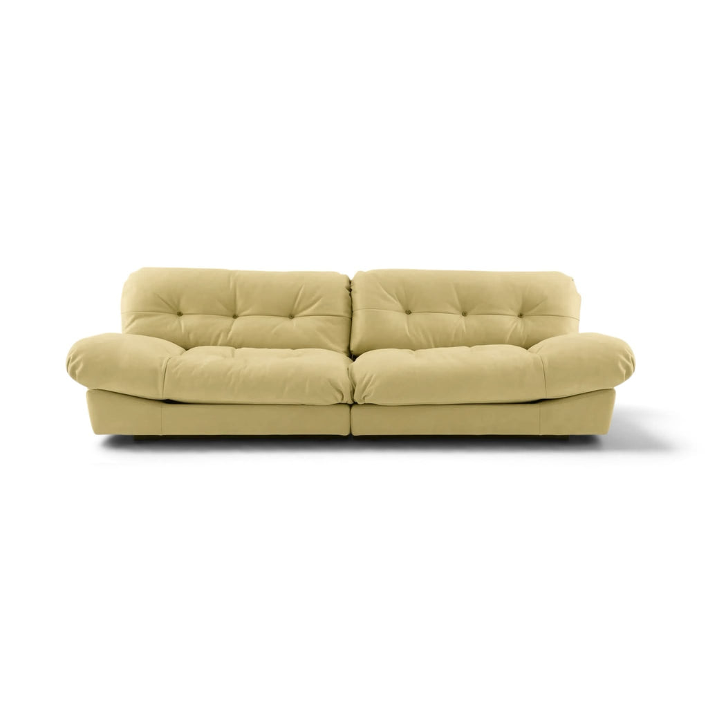 Milano two-seater sofa upholstered in light beige leather with tufted back cushions and rounded arms | Nue Modern