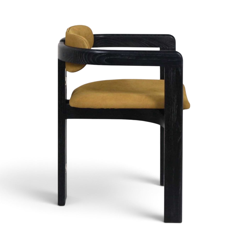 Side view of the Pamplona armchair with a black wooden frame and mustard yellow leather seat and back cushions | Nue Modern