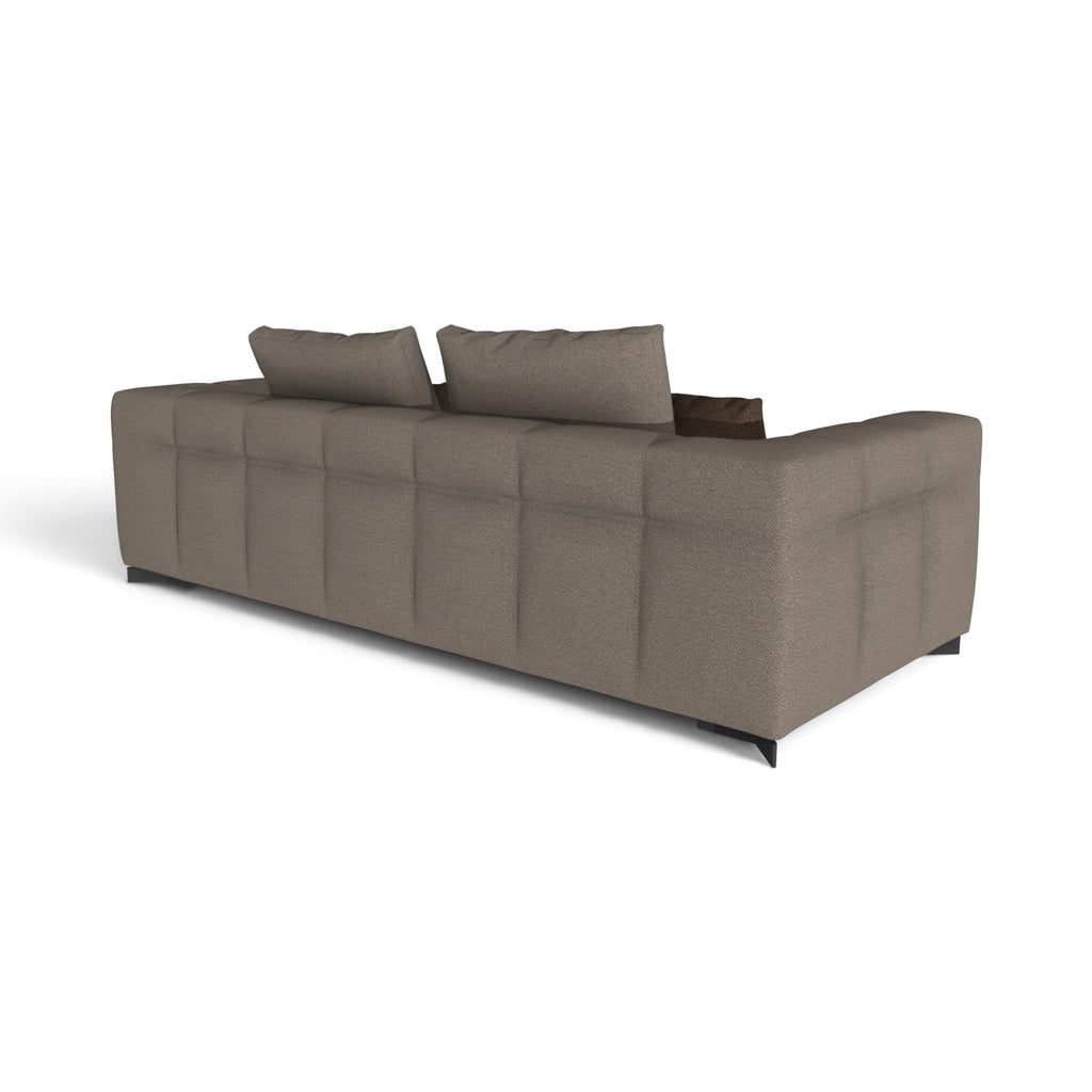 A modern upholstered sofa with a tufted backrest, shown from a three-quarters angle on a plain white background.