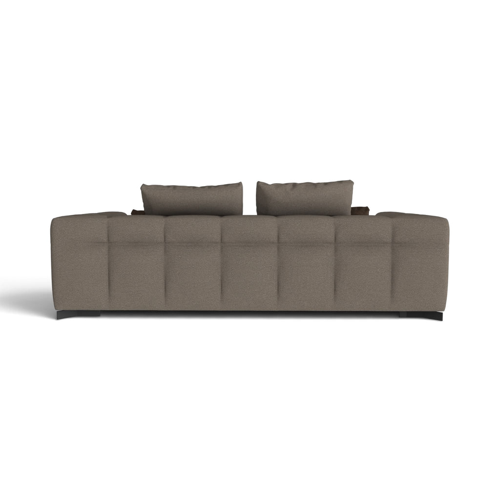 A modern upholstered sofa shown from the back, featuring a tufted backrest, two matching back cushions, and dark legs, in a solid taupe-brown fabric against a plain white background.