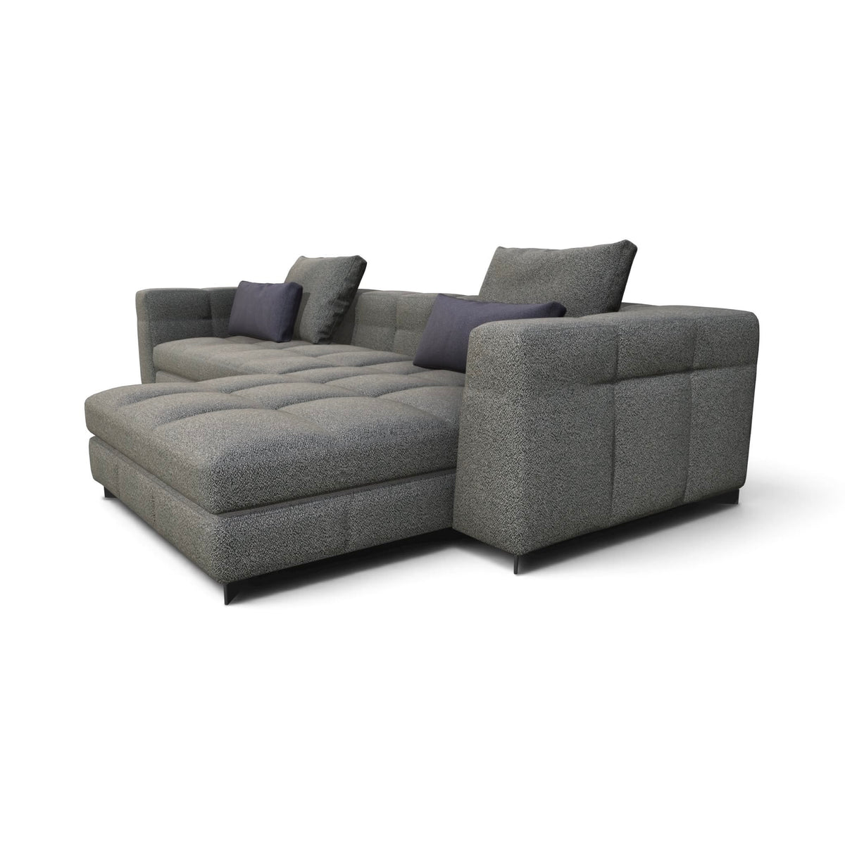 A modern gray fabric sectional sofa with a chaise lounge, featuring tufted cushions and three dark gray accent pillows, shown on a plain white background.