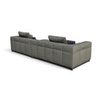 A modern sectional sofa in textured gray fabric with tufted channel stitching, shown from a three-quarters perspective on a white background.