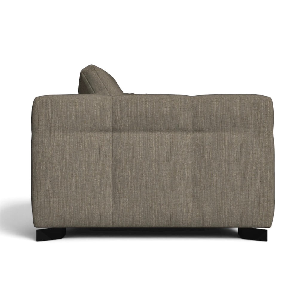 A modern upholstered sofa shown from the side against a plain white background.