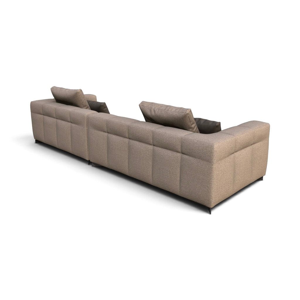 A modern two-seater sofa upholstered in a textured taupe fabric with a tufted grid pattern on the backrest and arms, shown from a three-quarters perspective on a white background.