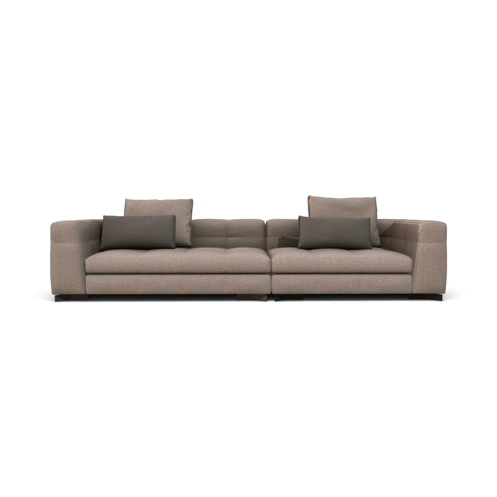 A modern two-seater sofa upholstered in a textured taupe-beige fabric, featuring two dark gray throw pillows and a low black base, shown against a plain white background.