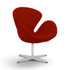 Swan chair in red upholstery with a sculptural curved shell and a chrome four-star base | Nue Modern