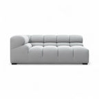 A modern light gray tufted sectional sofa with a right-facing armrest, shown from a front-facing perspective on a solid white background.