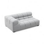 A modern light gray tufted modular sofa or lounge chair with a low, rounded blocky design, shown on a plain white background.