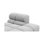 Close-up of a light grey tufted upholstered Tufty TF018 on a plain white background.
