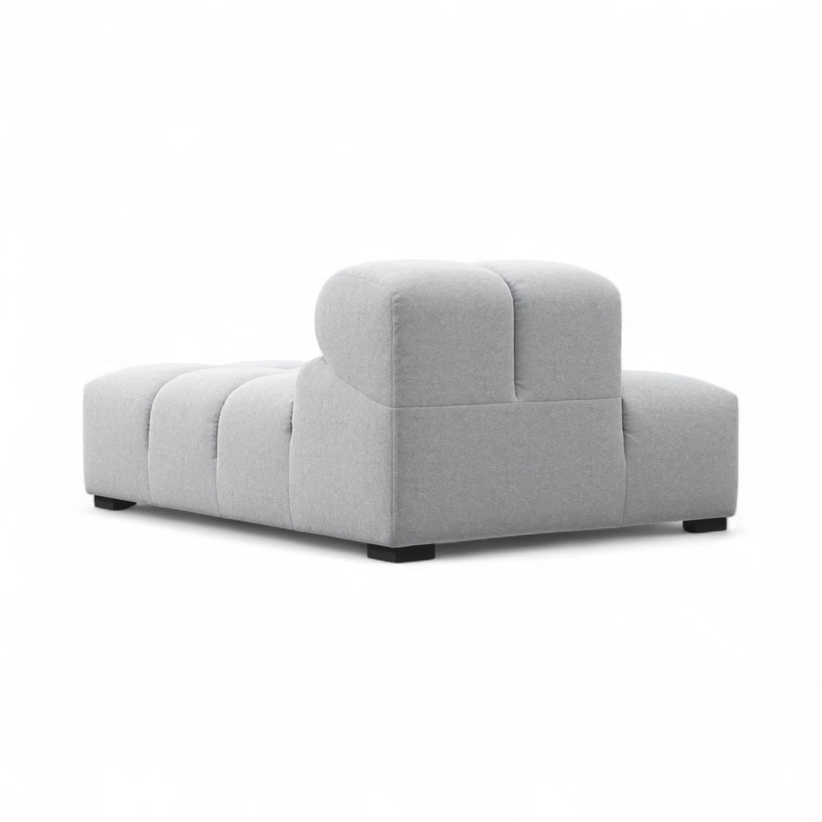 A light-grey upholstered Tufty TF018 sofa with a low, blocky design and dark feet, shown at a three-quarter angle